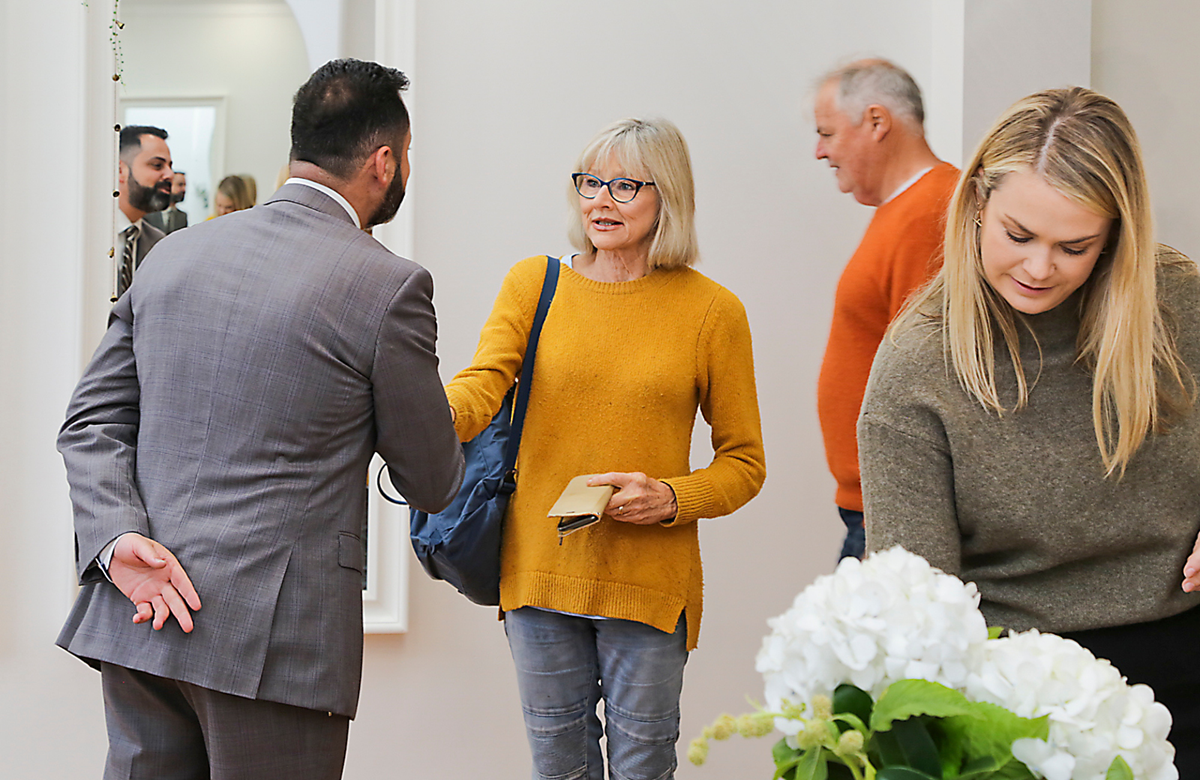 Belle Property agent greeting clients in the home at an open home inspection